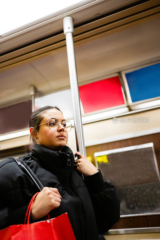Young Woman Riding the Subway in NYC
